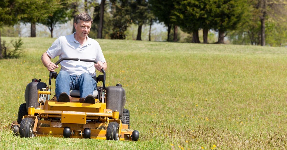 Man driving zero turn lawn mower